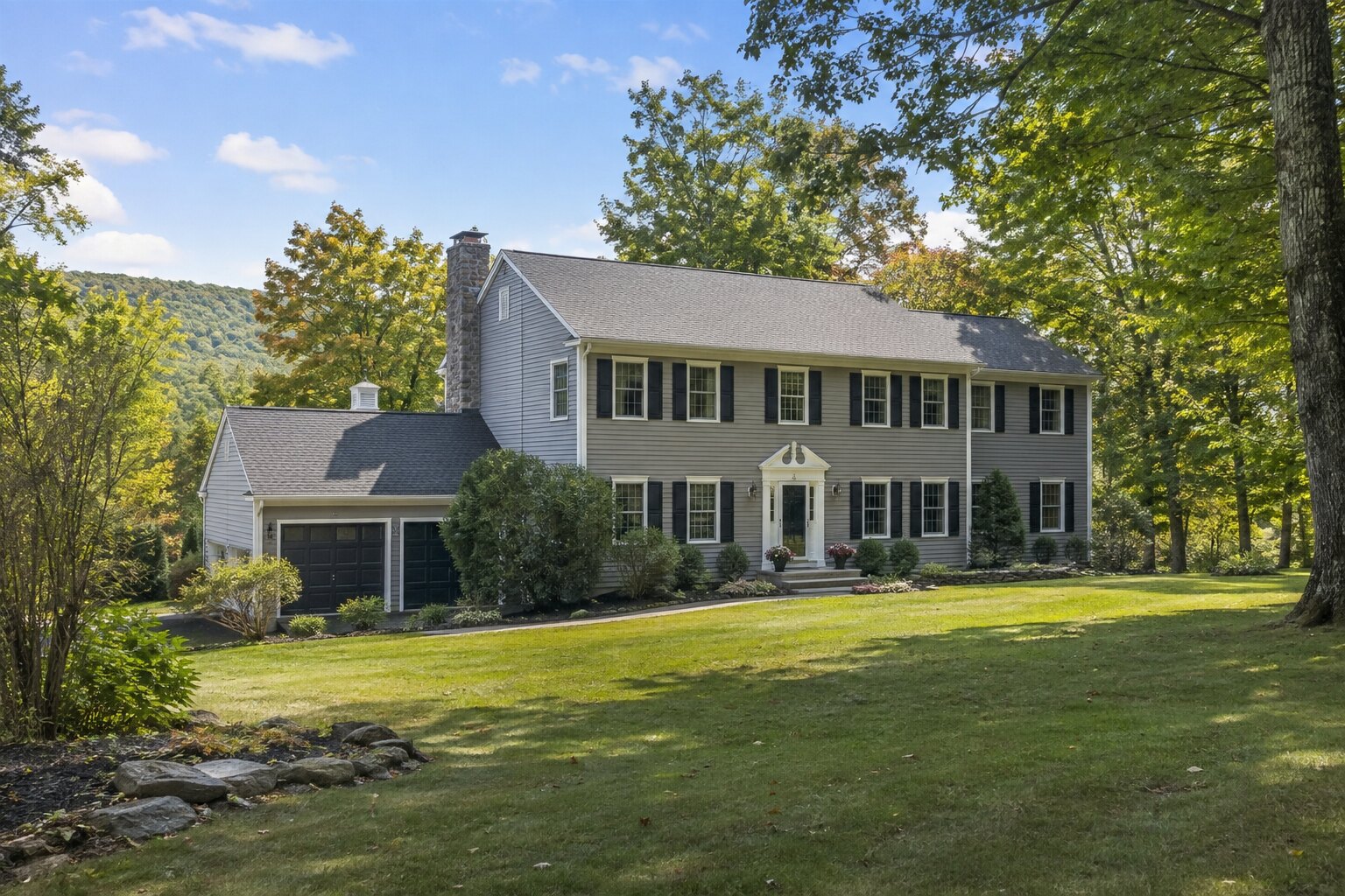 Wooded colonial home representing a residential listing in northern New Jersey